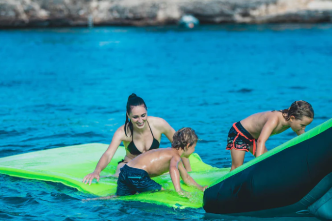 a young girl riding a wave on a surfboard in the water