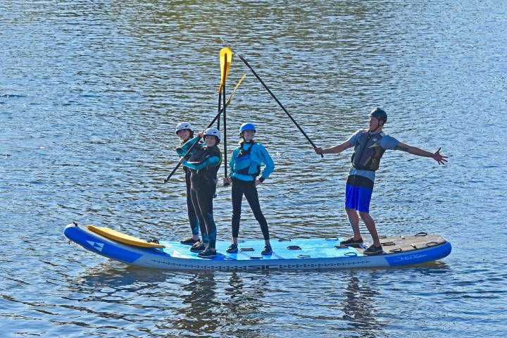 a group of people riding skis on a body of water